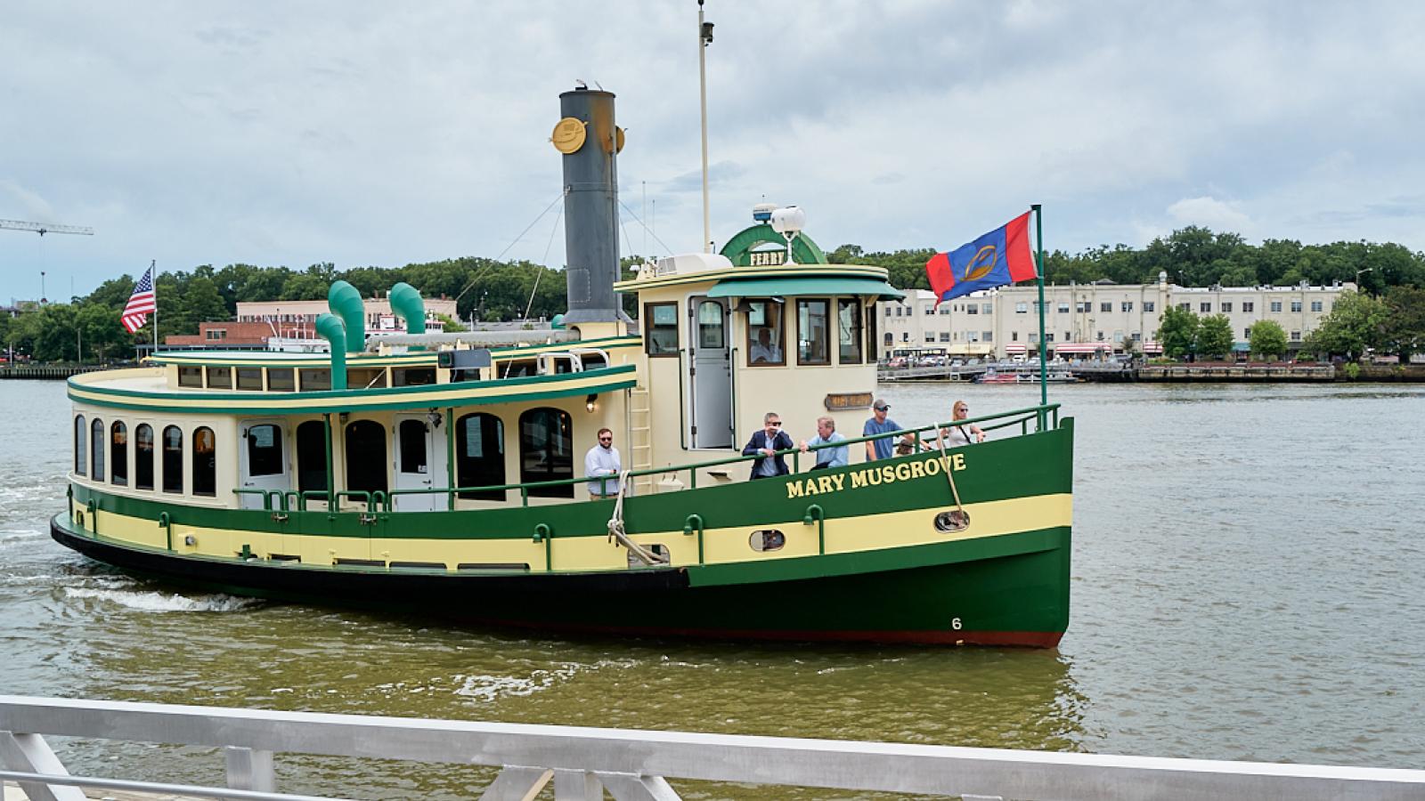 Green and white boat taxi on the river