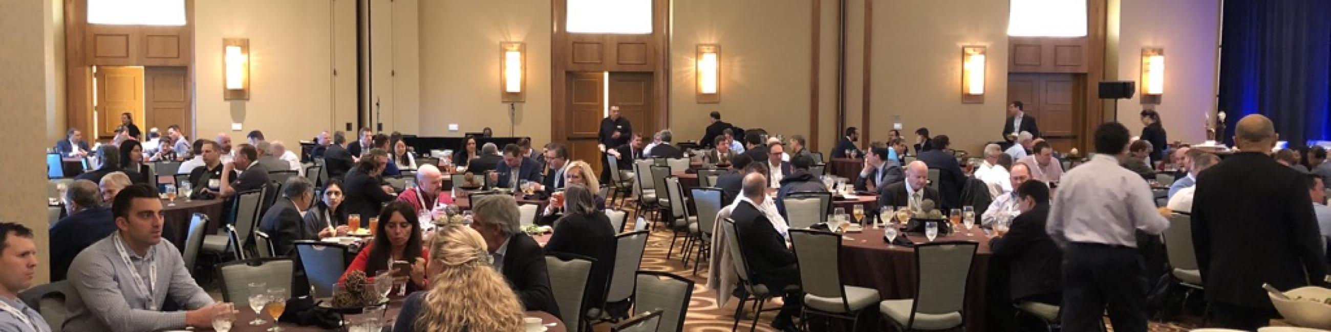 Photo of Trade show attendees at round tables